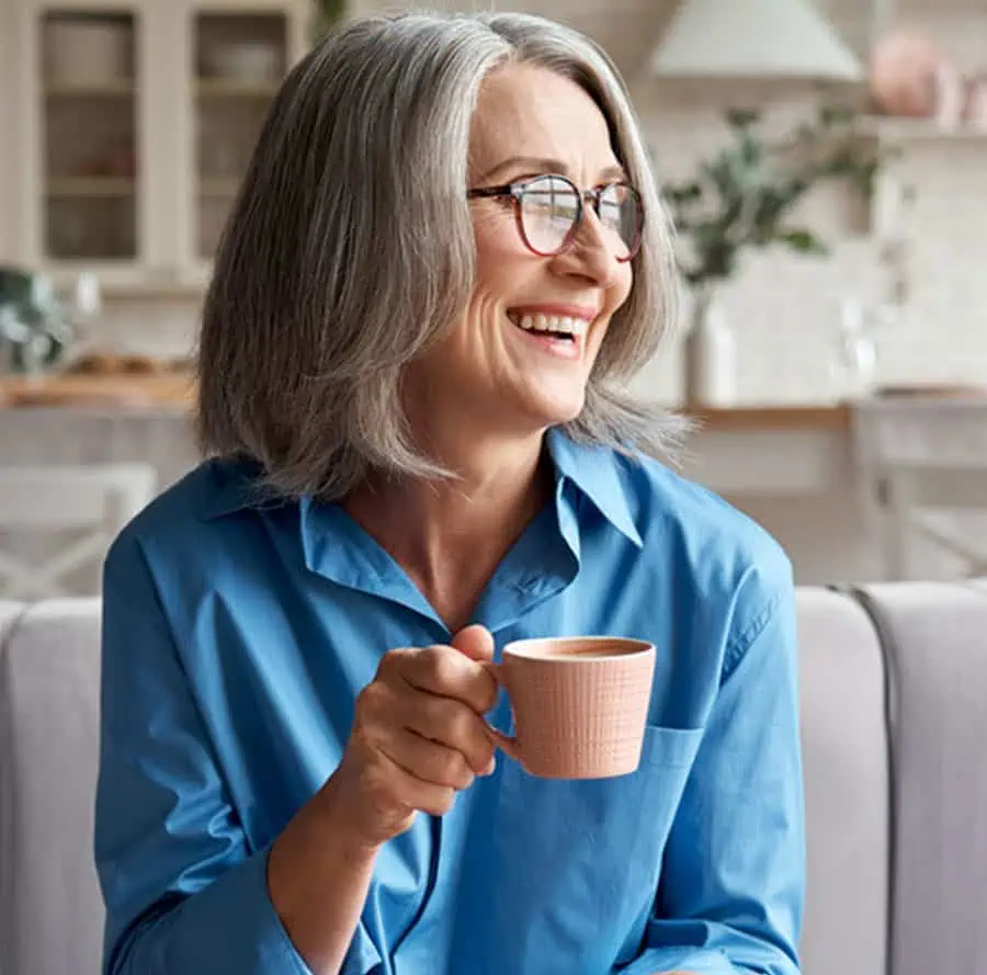 Woman smiling confidently after receiving restorative dentistry in Asheville, showcasing the positive results of comprehensive care and personalized attention.